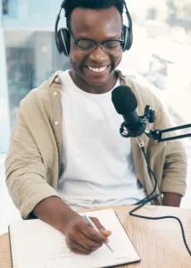 Live stream, podcast or black man with notebook, microphone or headphones with news broadcasting. S.
